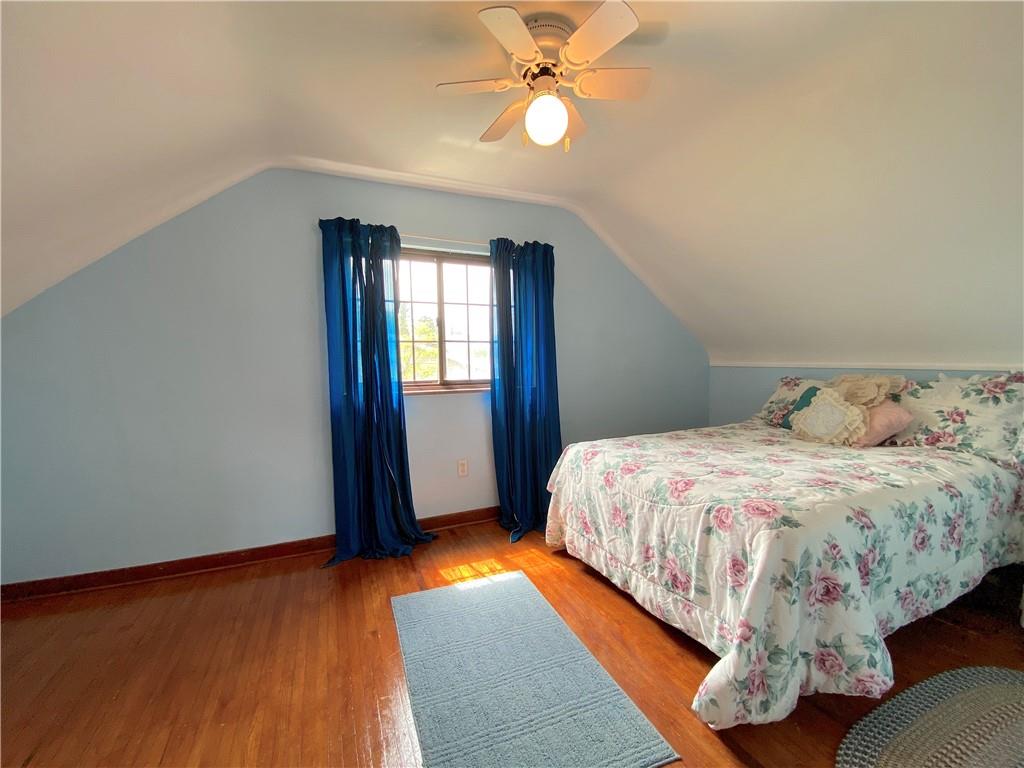 560 Center Hill Road Pittsburgh, PA 15239 - Photo 21 of 25 a bed sitting in a spacious bedroom next to a window and a chandelier