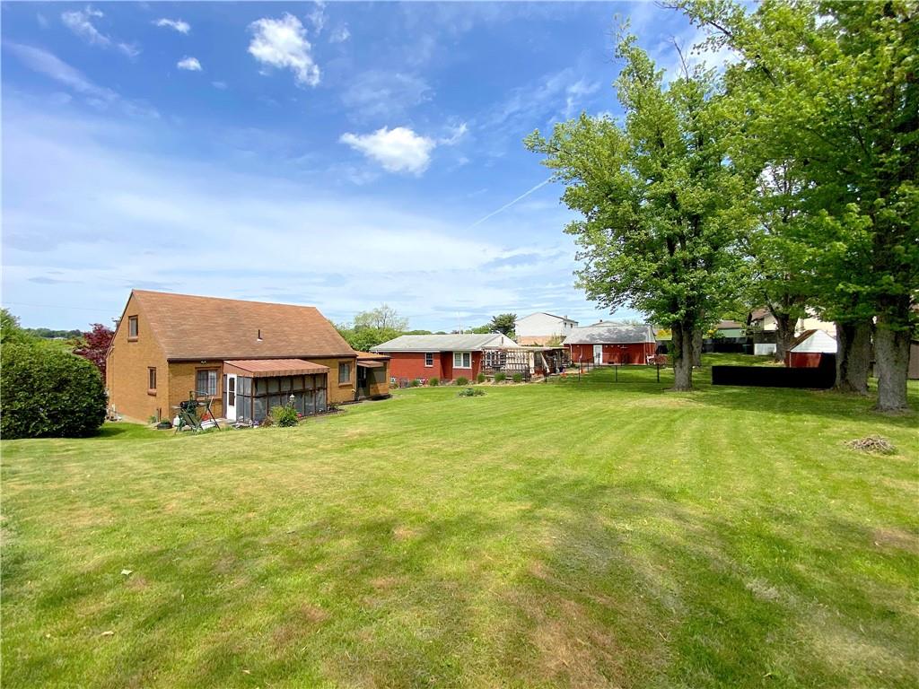 560 Center Hill Road Pittsburgh, PA 15239 - Photo 25 of 25 a car parked in front of a house with a big yard