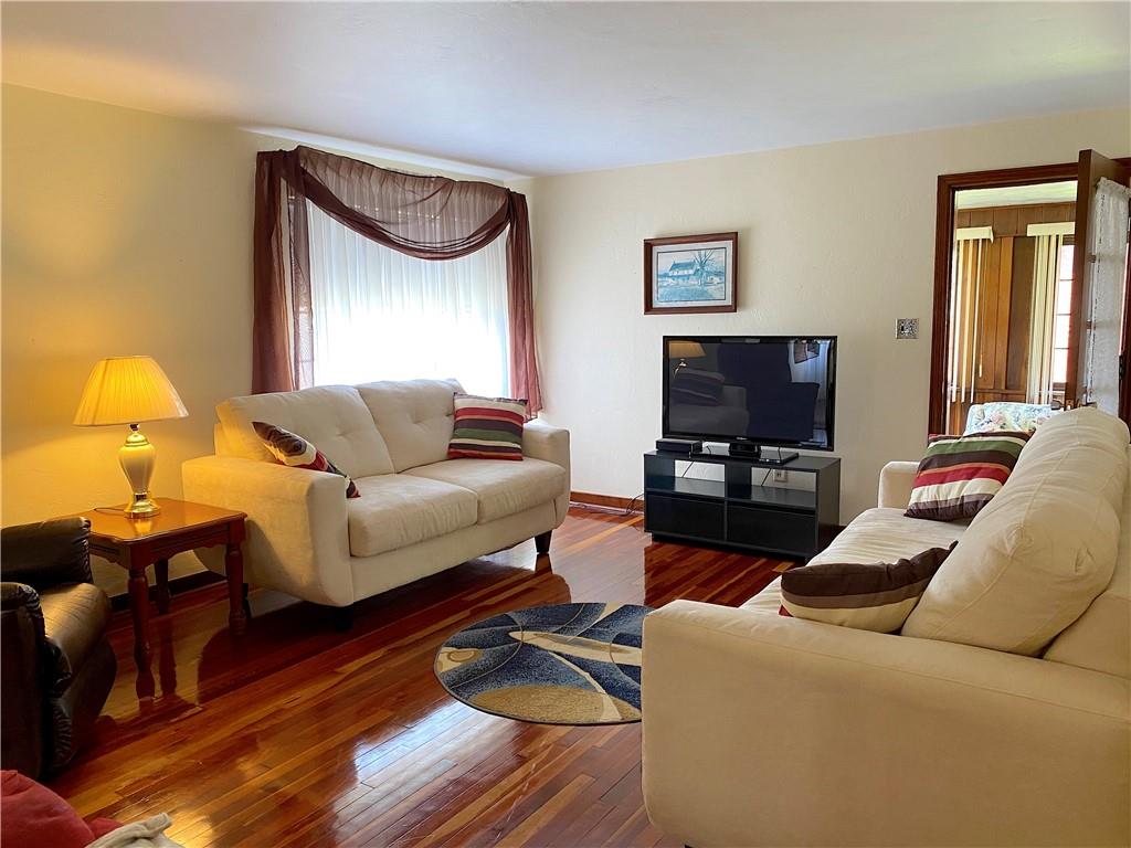 560 Center Hill Road Pittsburgh, PA 15239 - Photo 7 of 25 a living room with furniture and a flat screen tv