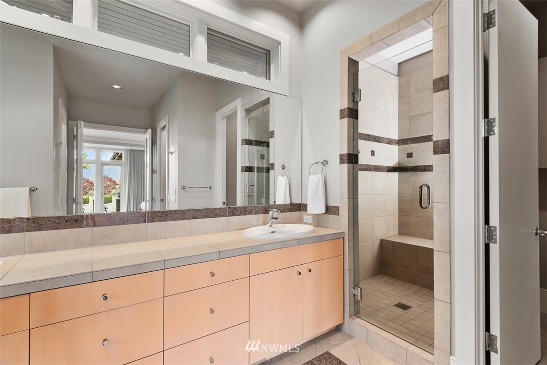 925 Park Road Bellevue, WA 98004 - Photo 14 of 25 a bathroom with a shower sink and mirror