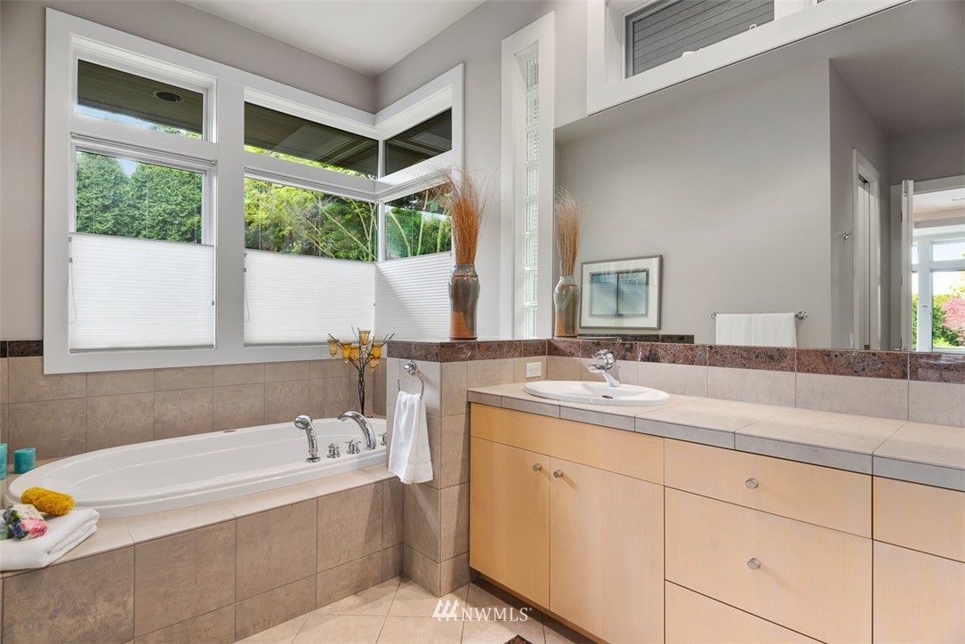 925 Park Road Bellevue, WA 98004 - Photo 15 of 25 a bathroom with a tub a sink and a window