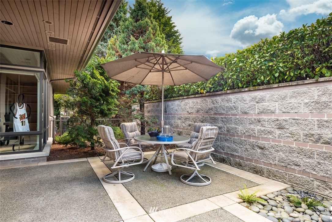 925 Park Road Bellevue, WA 98004 - Photo 25 of 25 a view of a patio with a table and chairs under an umbrella with a chair