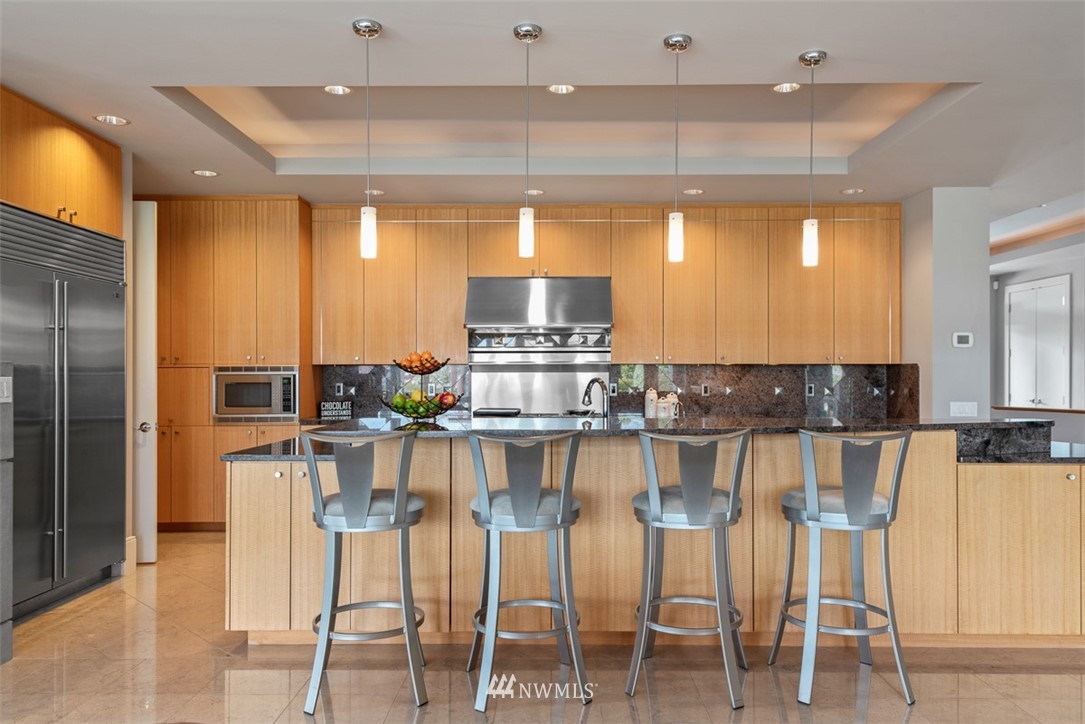 925 Park Road Bellevue, WA 98004 - Photo 9 of 25 a kitchen with a table chairs refrigerator and microwave
