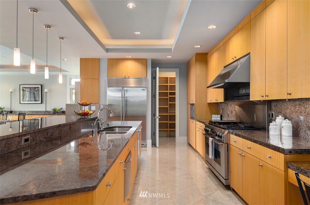 925 Park Road Bellevue, WA 98004 - Photo 10 of 25 a kitchen with stainless steel appliances granite countertop a sink a stove and a refrigerator