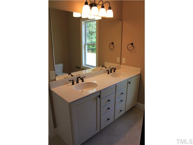 2101 Scarlet Maple Drive Raleigh, NC 27606 - Photo 11 of 18 a bathroom with a sink double vanity and a mirror
