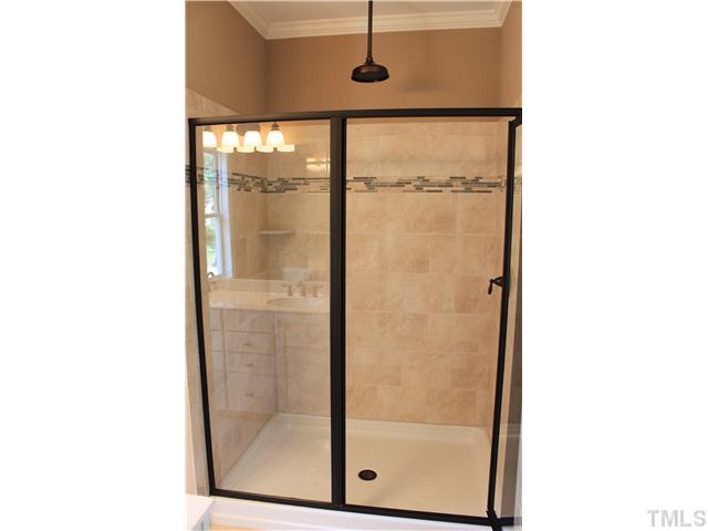 2101 Scarlet Maple Drive Raleigh, NC 27606 - Photo 13 of 18 a bathroom with a glass shower door