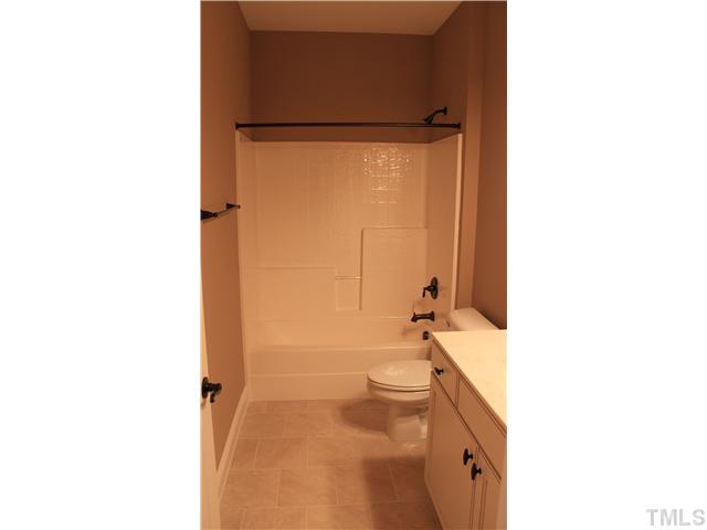 2101 Scarlet Maple Drive Raleigh, NC 27606 - Photo 14 of 18 a bathroom with a granite countertop sink toilet and shower