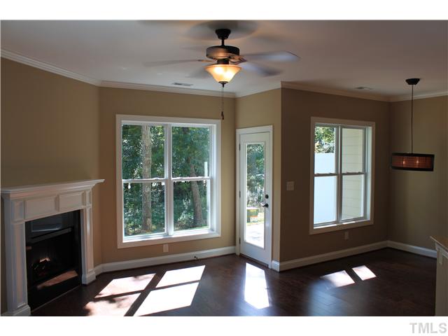 2101 Scarlet Maple Drive Raleigh, NC 27606 - Photo 3 of 18 a living room with a fireplace furniture and a large window