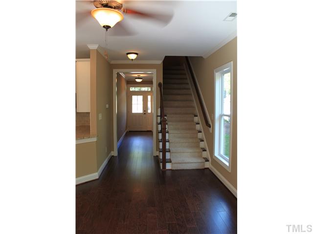 2101 Scarlet Maple Drive Raleigh, NC 27606 - Photo 4 of 18 a view of a hallway with wooden floor