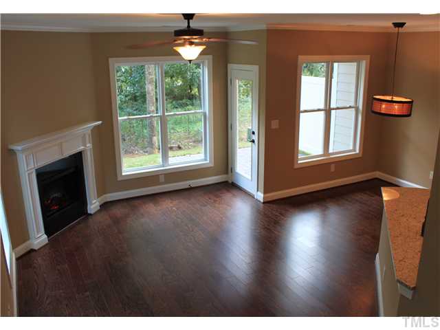 2101 Scarlet Maple Drive Raleigh, NC 27606 - Photo 5 of 18 a view of a livingroom with wooden floor and a fireplace
