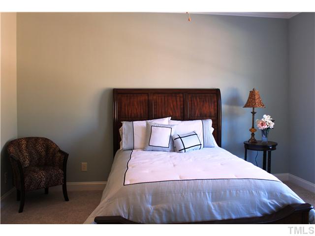 2101 Scarlet Maple Drive Raleigh, NC 27606 - Photo 8 of 18 a bedroom with a bed and a chair