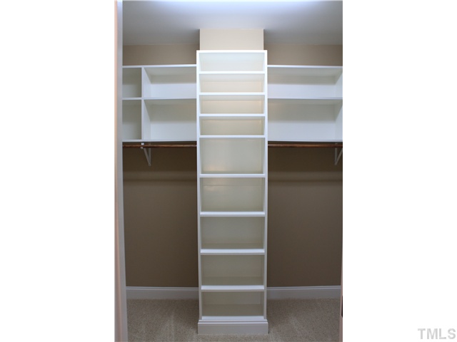 2101 Scarlet Maple Drive Raleigh, NC 27606 - Photo 9 of 18 a view of an empty walk in closet with empty racks