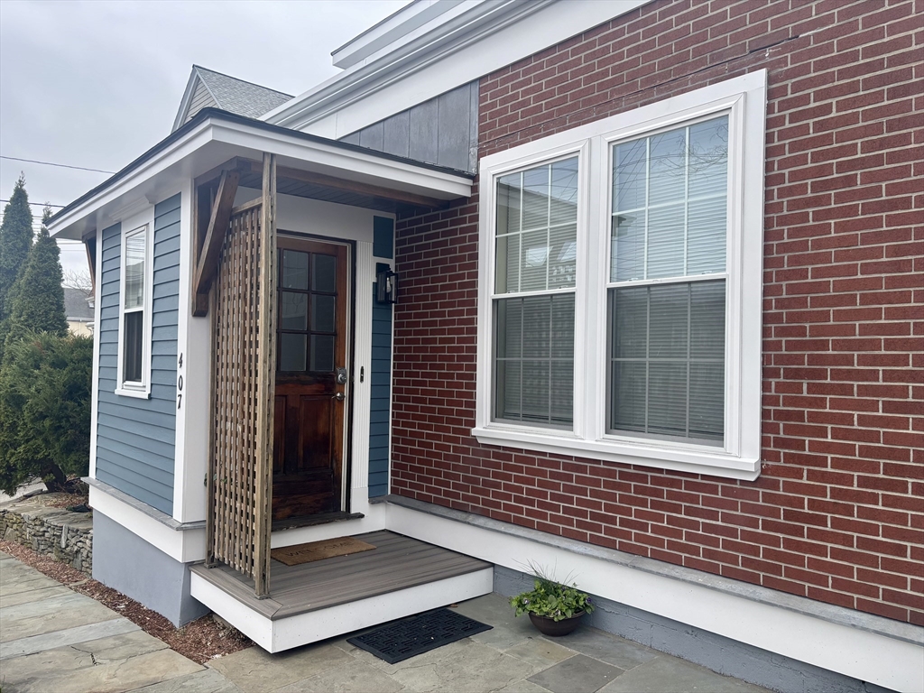 407 Main Street, Unit A Medford, MA 02155 - Photo 1 of 4 a front view of a house with a porch