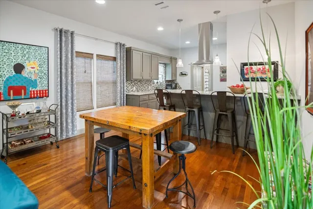 a view of a dining room with furniture and a floor to ceiling window