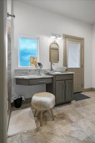 a living room with a sink and chairs