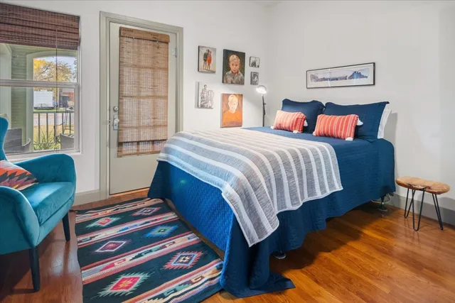 a bedroom with furniture and wooden floor