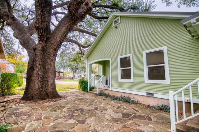 a front view of a house with a garden