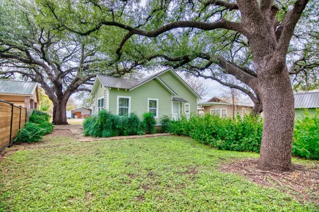 a house that has a tree in front of it