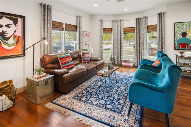 a living room with furniture and a floor to ceiling window