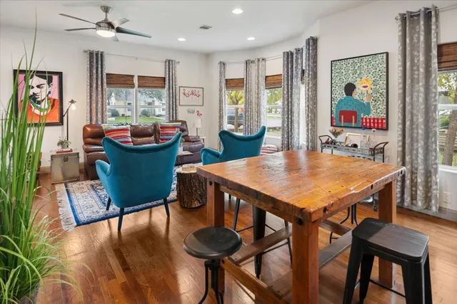a view of a dining room with furniture a chandelier and wooden floor