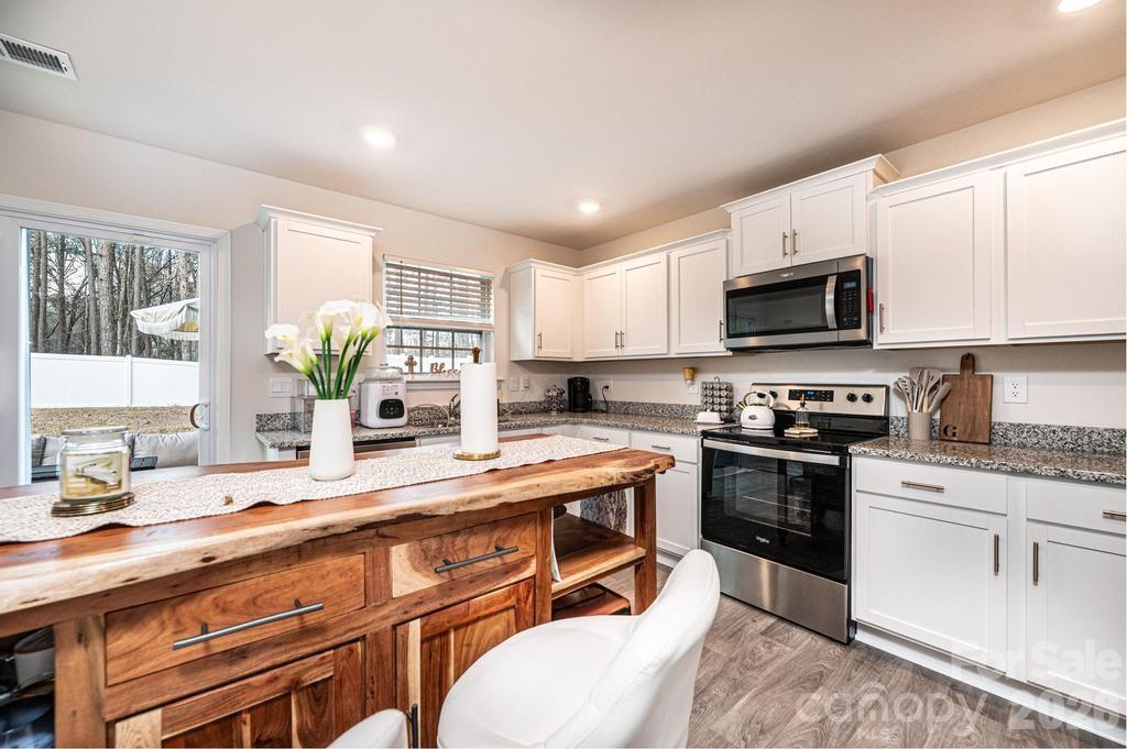 1808 Bright Hope Lane Dallas, NC 28034 - Photo 16 of 44 a kitchen with stainless steel appliances a stove sink microwave and cabinets