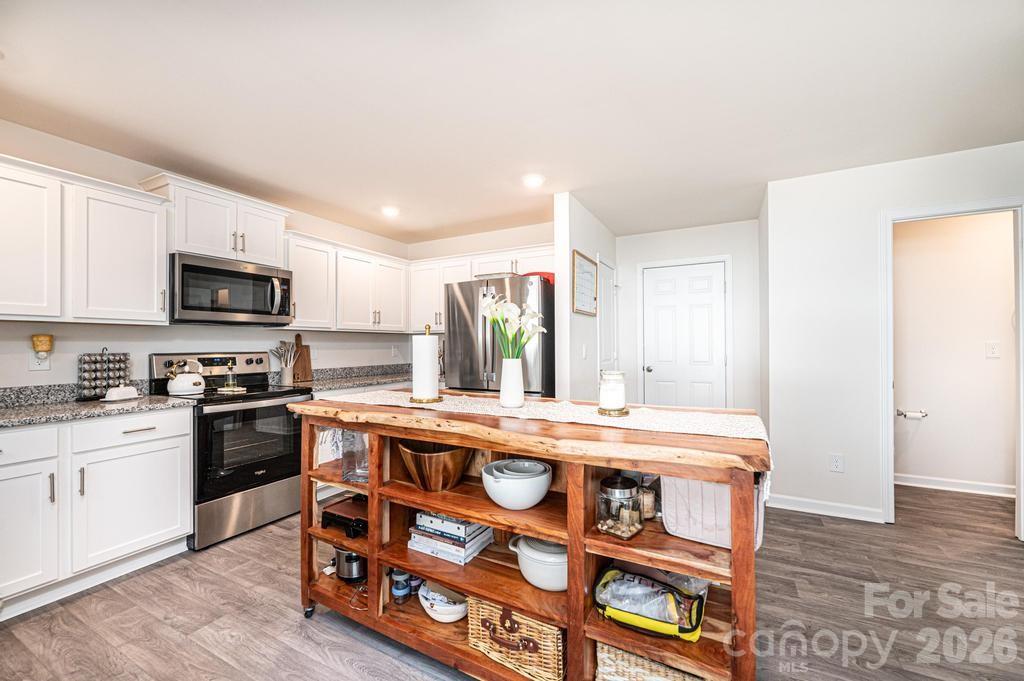 1808 Bright Hope Lane Dallas, NC 28034 - Photo 17 of 44 a kitchen with a stove a sink and a refrigerator