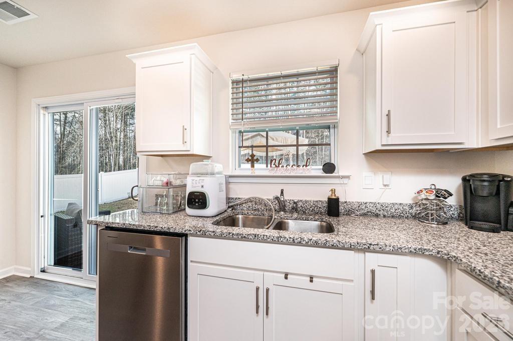 1808 Bright Hope Lane Dallas, NC 28034 - Photo 20 of 44 a kitchen with granite countertop a sink a window and cabinets