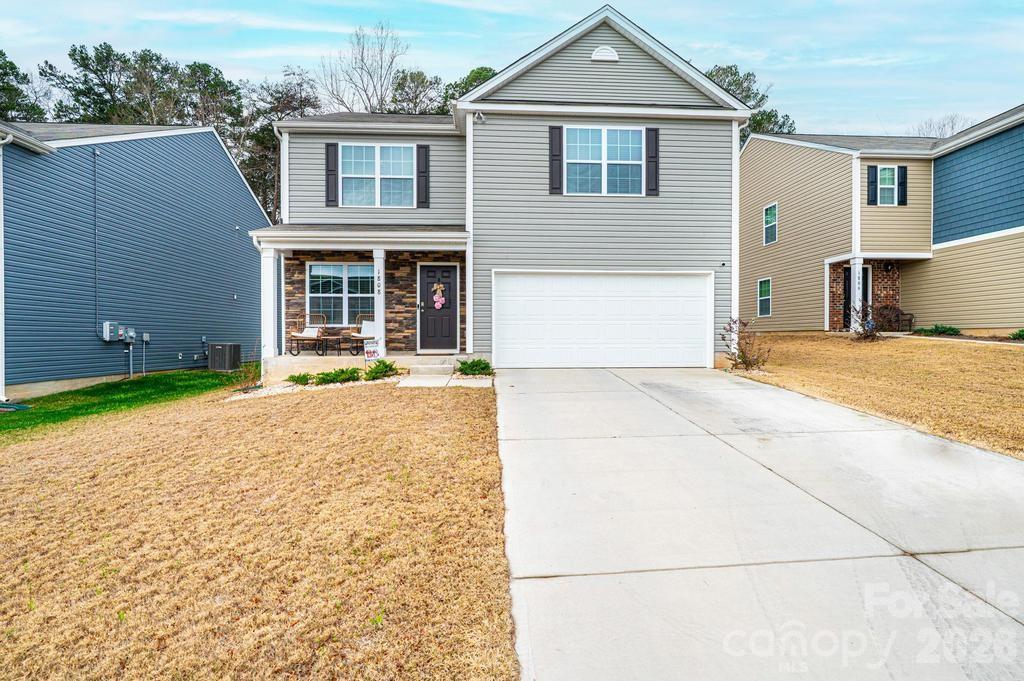 1808 Bright Hope Lane Dallas, NC 28034 - Photo 2 of 44 a front view of a house with a yard and garage