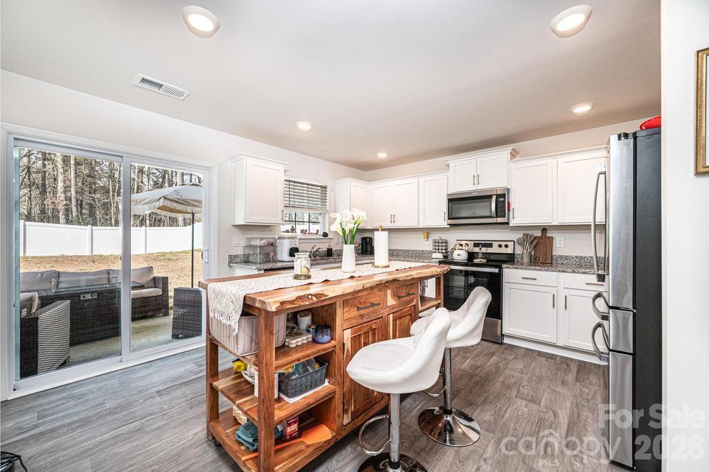 1808 Bright Hope Lane Dallas, NC 28034 - Photo 21 of 44 a large kitchen with kitchen island granite countertop lots of counter space and stainless steel appliances