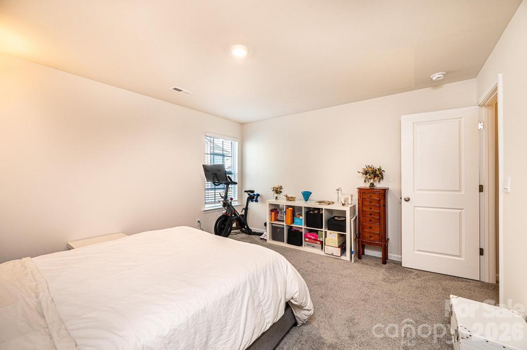1808 Bright Hope Lane Dallas, NC 28034 - Photo 26 of 44 a bedroom with a bed and a large mirror
