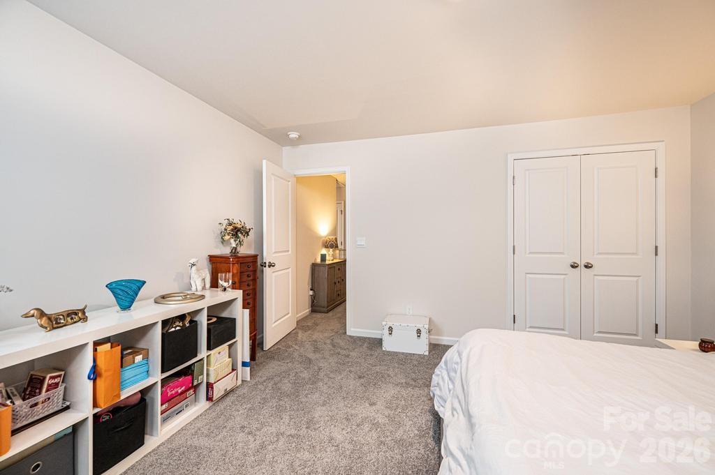 1808 Bright Hope Lane Dallas, NC 28034 - Photo 27 of 44 a bed room with a bed and a book shelf