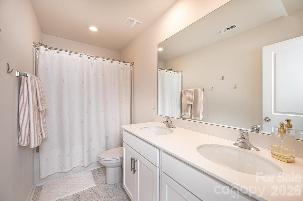 1808 Bright Hope Lane Dallas, NC 28034 - Photo 33 of 44 a bathroom with a double vanity sink toilet and a mirror