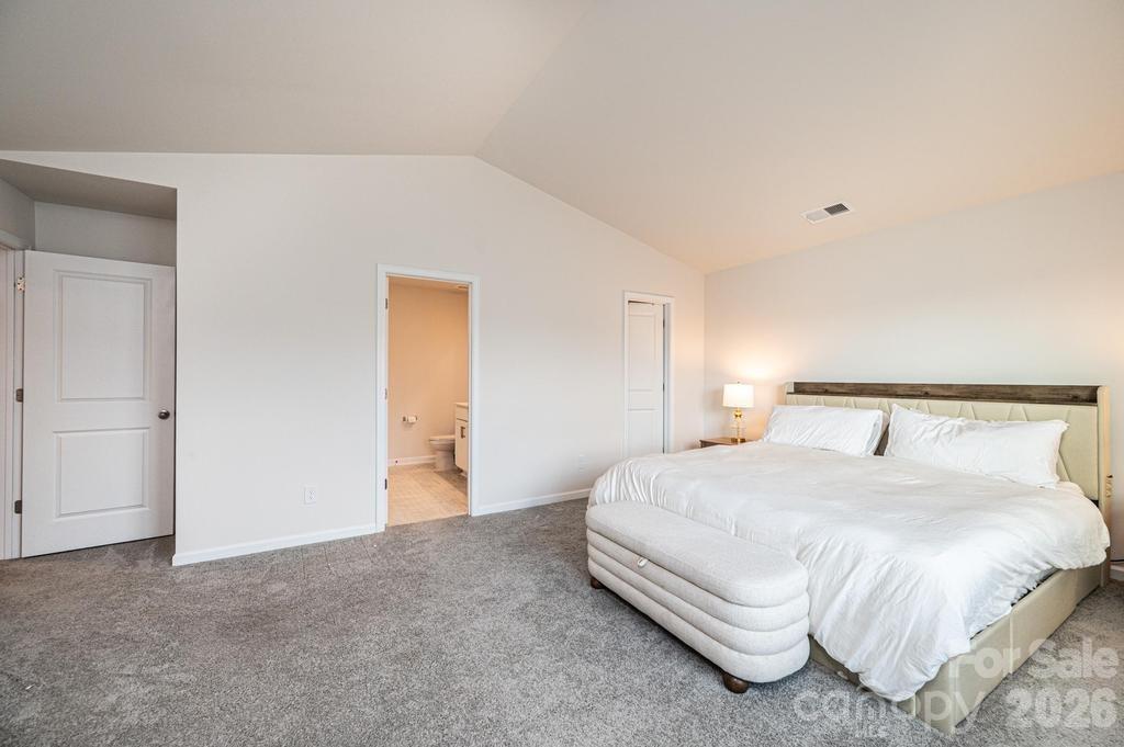 1808 Bright Hope Lane Dallas, NC 28034 - Photo 38 of 44 a spacious bedroom with a bed and a painting