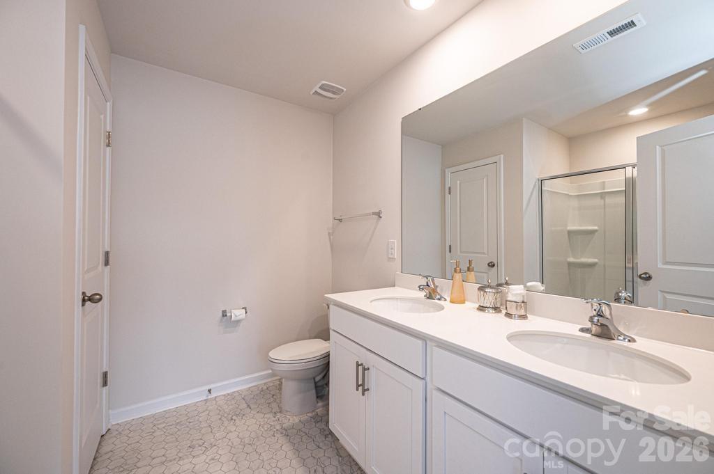 1808 Bright Hope Lane Dallas, NC 28034 - Photo 40 of 44 a bathroom with a double vanity sink toilet and mirror