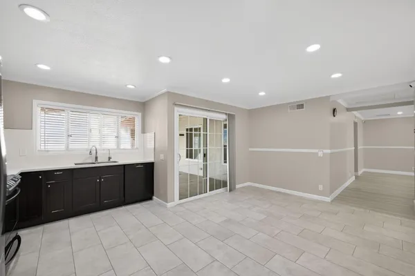 a large kitchen with stainless steel appliances kitchen island granite countertop a refrigerator and a stove top oven