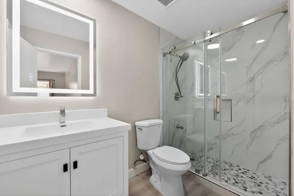 a bathroom with a sink toilet and shower