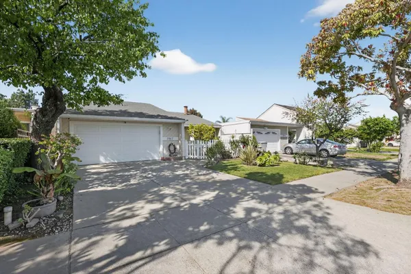 a view of a house with a yard and sitting area