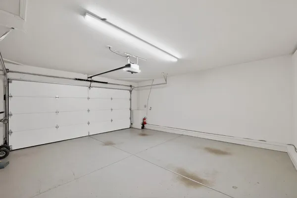 an empty room with wooden floor and mirror