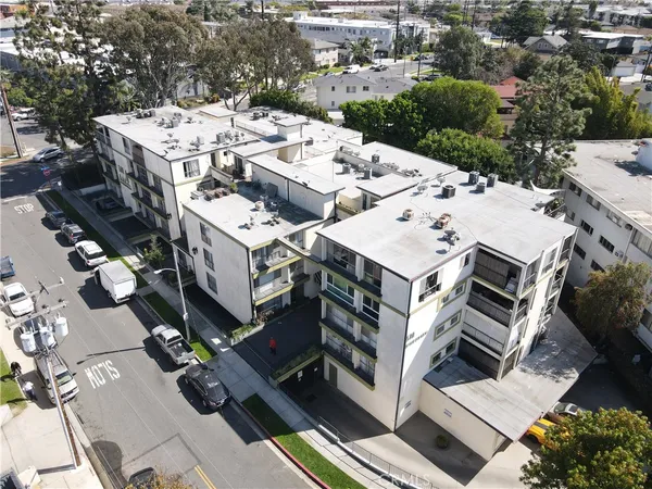 an aerial view of a residential building with parking space
