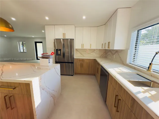 a kitchen with refrigerator and window