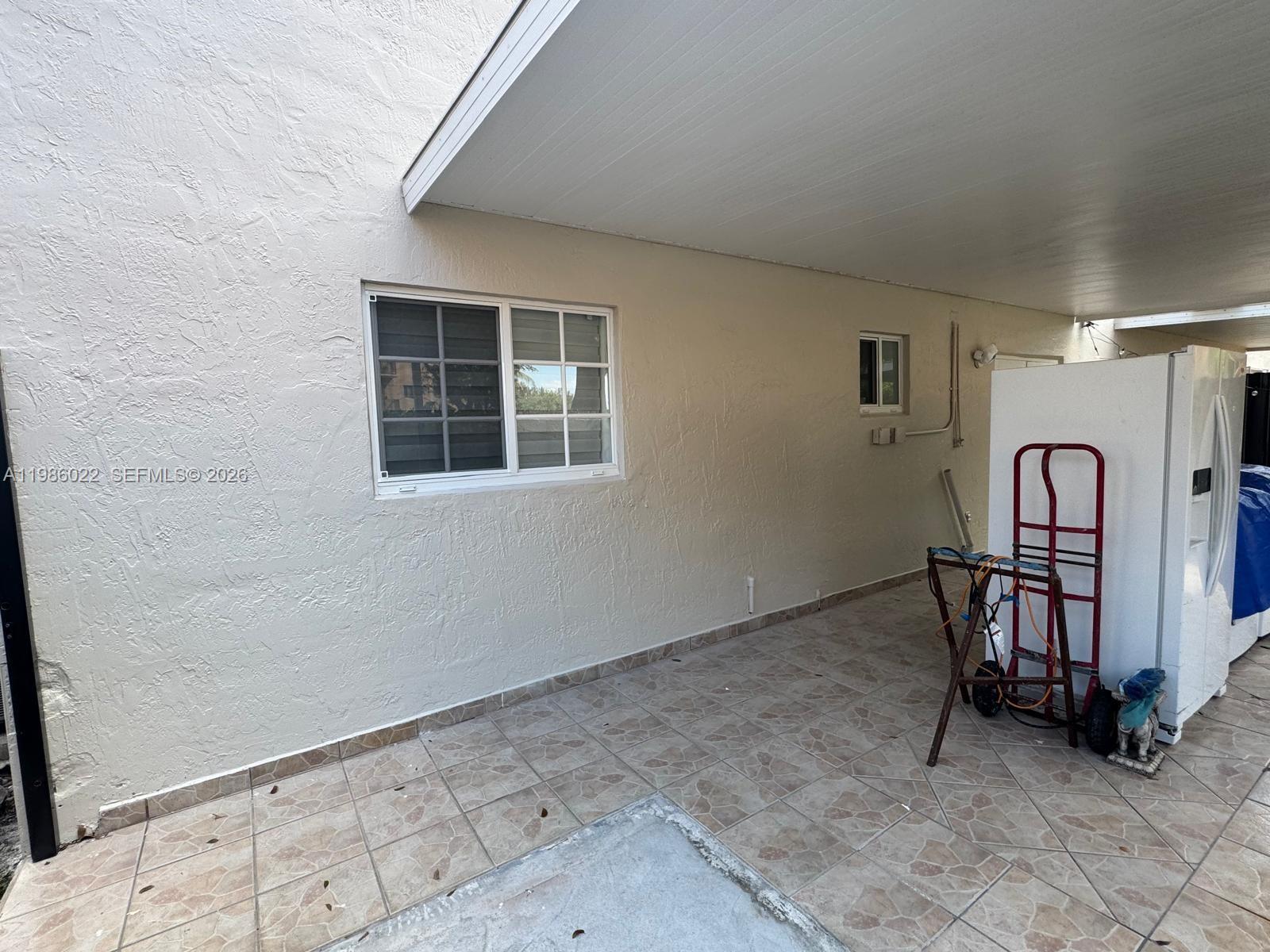 10101 West Okeechobee Road, Unit 12101 Hialeah Gardens, FL 33016 - Photo 12 of 12 a view of a livingroom with furniture and white walls