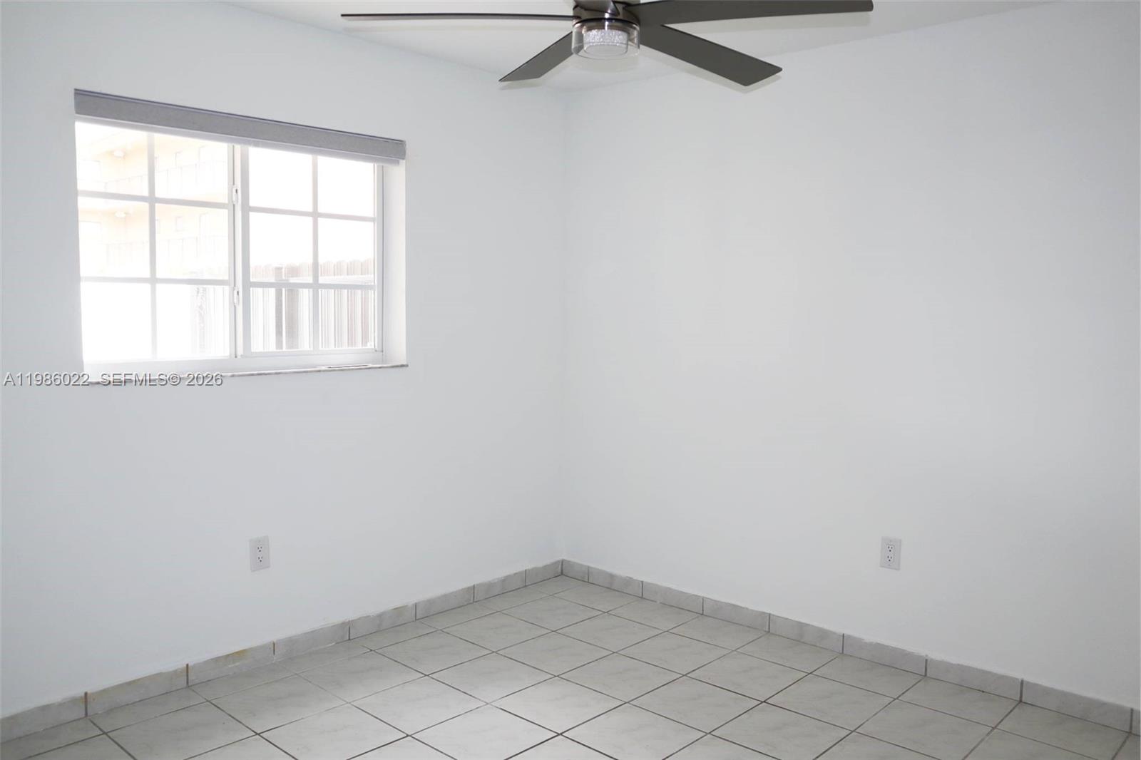 10101 West Okeechobee Road, Unit 12101 Hialeah Gardens, FL 33016 - Photo 4 of 12 an empty room with a window