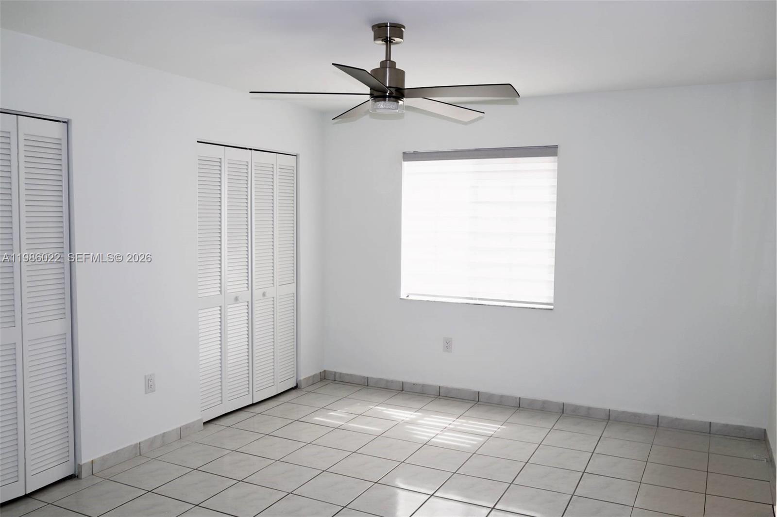 10101 West Okeechobee Road, Unit 12101 Hialeah Gardens, FL 33016 - Photo 6 of 12 a view of an empty room and chandelier fan