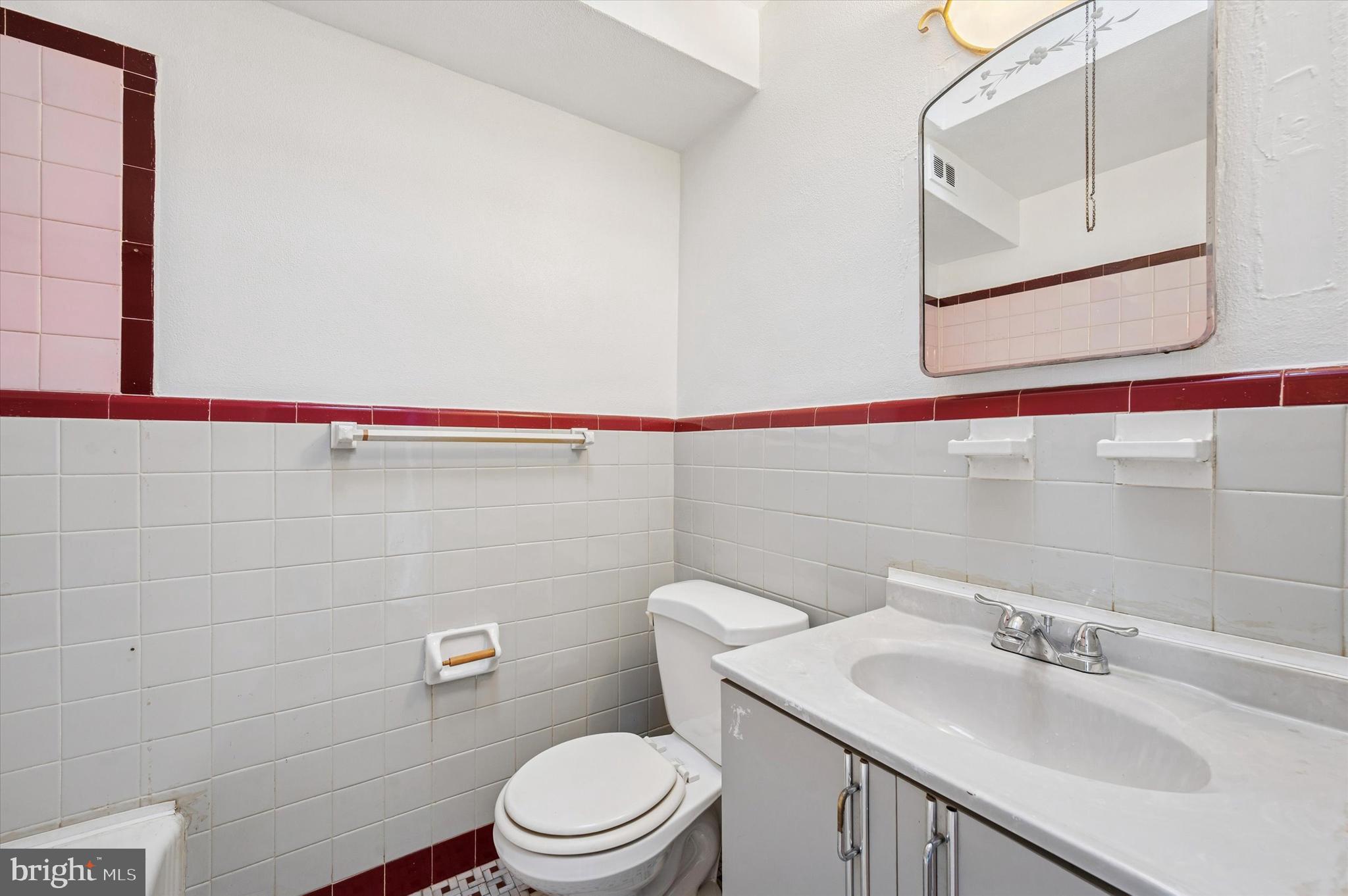 6320 Everett Street Philadelphia, PA 19149 - Photo 8 of 12 a bathroom with a sink a toilet and mirror