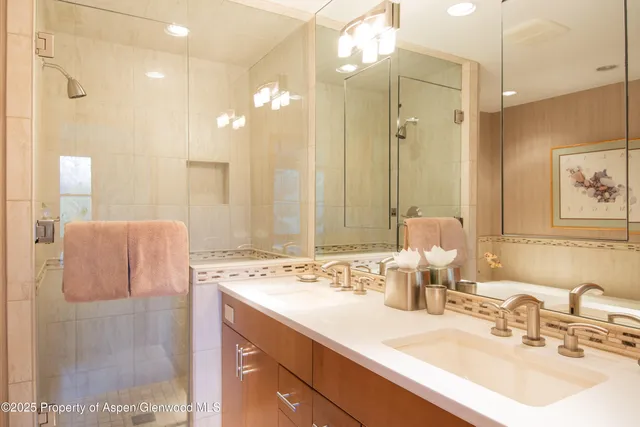 a bathroom with a double vanity sink mirror and double