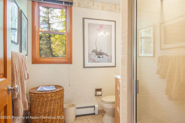 a bathroom with a toilet a sink and a shower