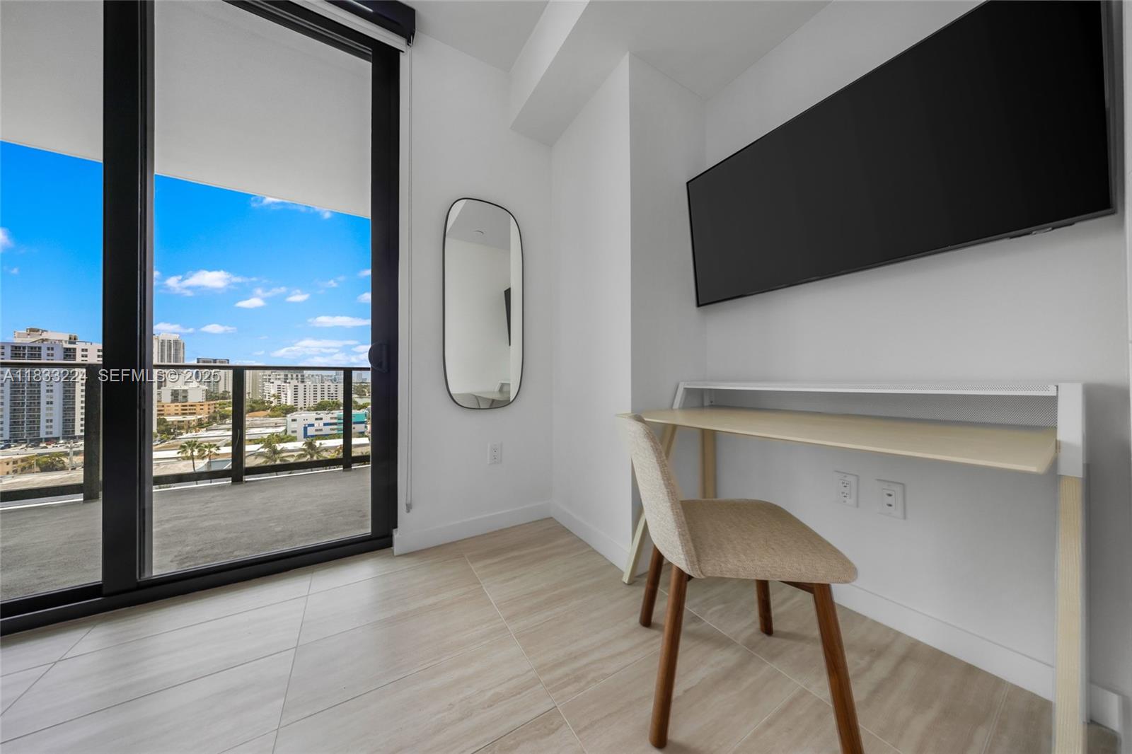 580 72nd Street, Unit 910 Miami Beach, FL 33141 - Photo 51 of 60 a view of a livingroom with furniture a flat screen tv and outdoor view