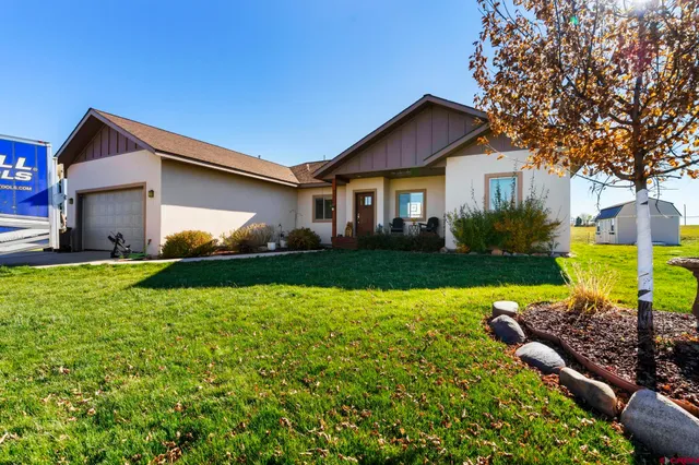 a front view of house with yard and green space