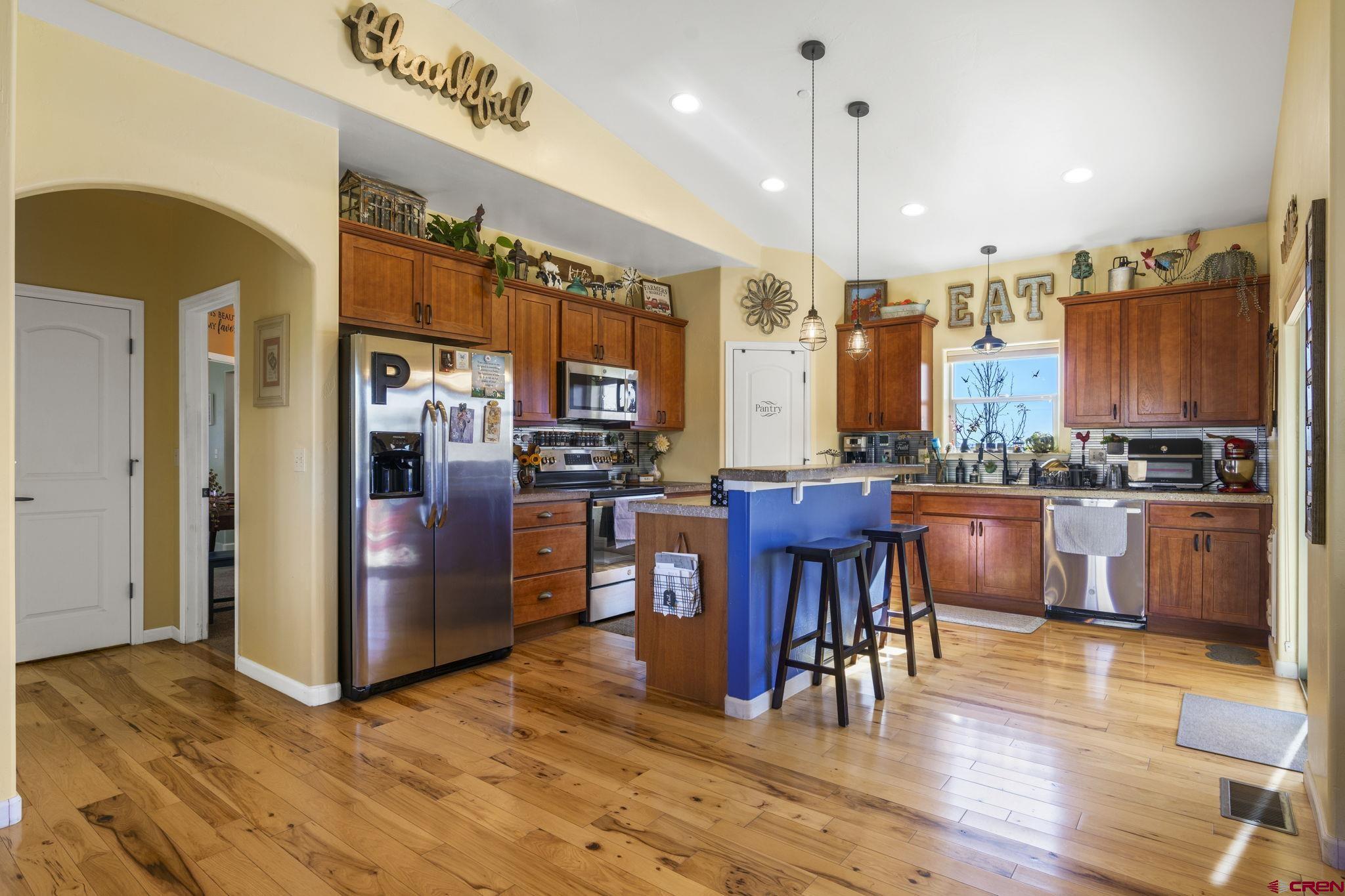 172 Encantado Lane Durango, CO 81303 - Photo 11 of 38 a view of kitchen with stainless steel appliances granite countertop a refrigerator and a stove top oven