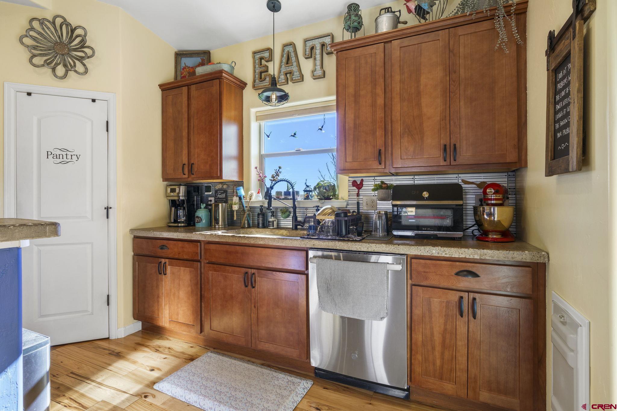 172 Encantado Lane Durango, CO 81303 - Photo 14 of 38 a kitchen with stainless steel appliances granite countertop a refrigerator a sink and wooden cabinets